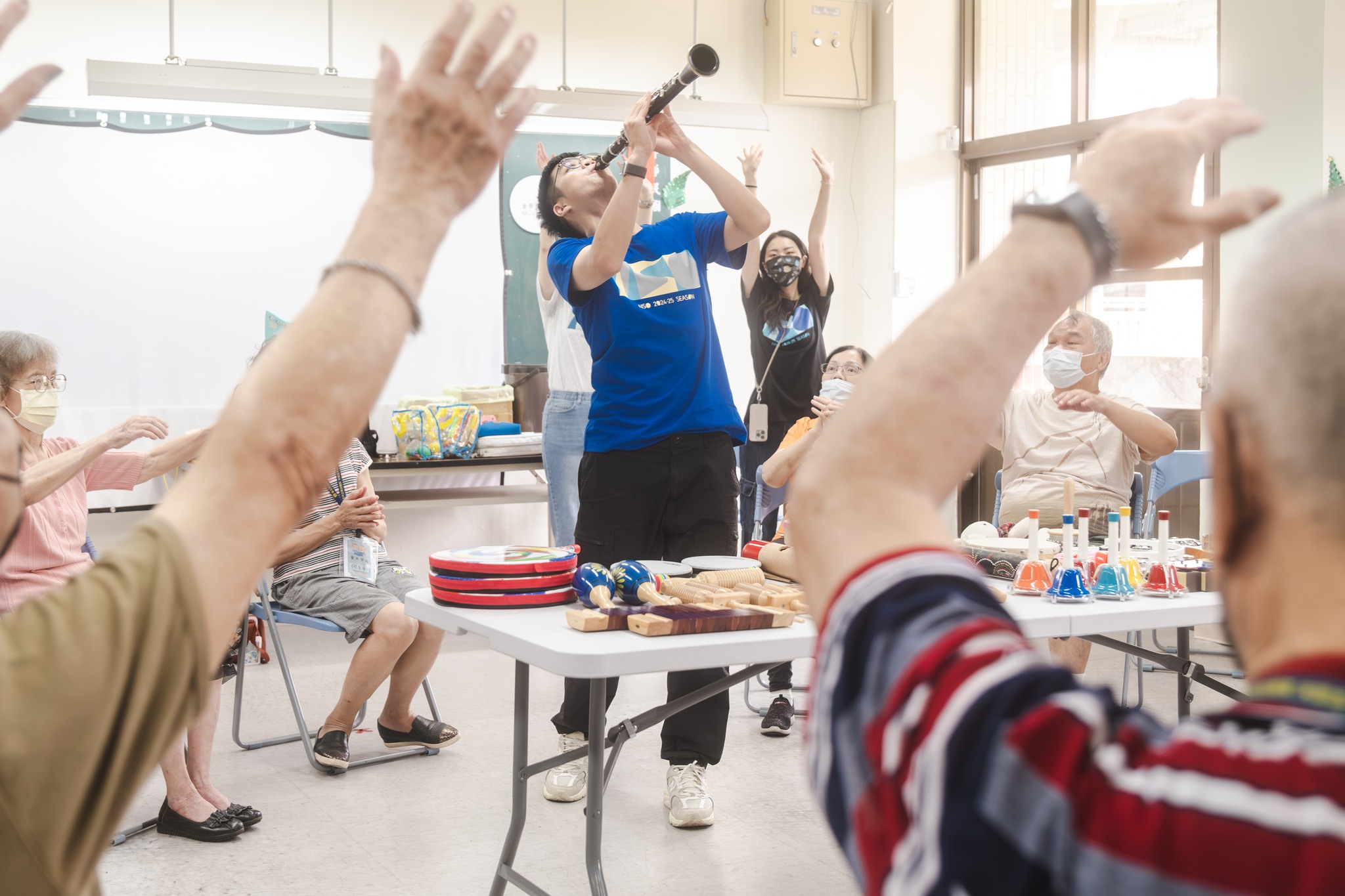 Seniors and music pathfinders enjoying a music activity together in the senior music care program.