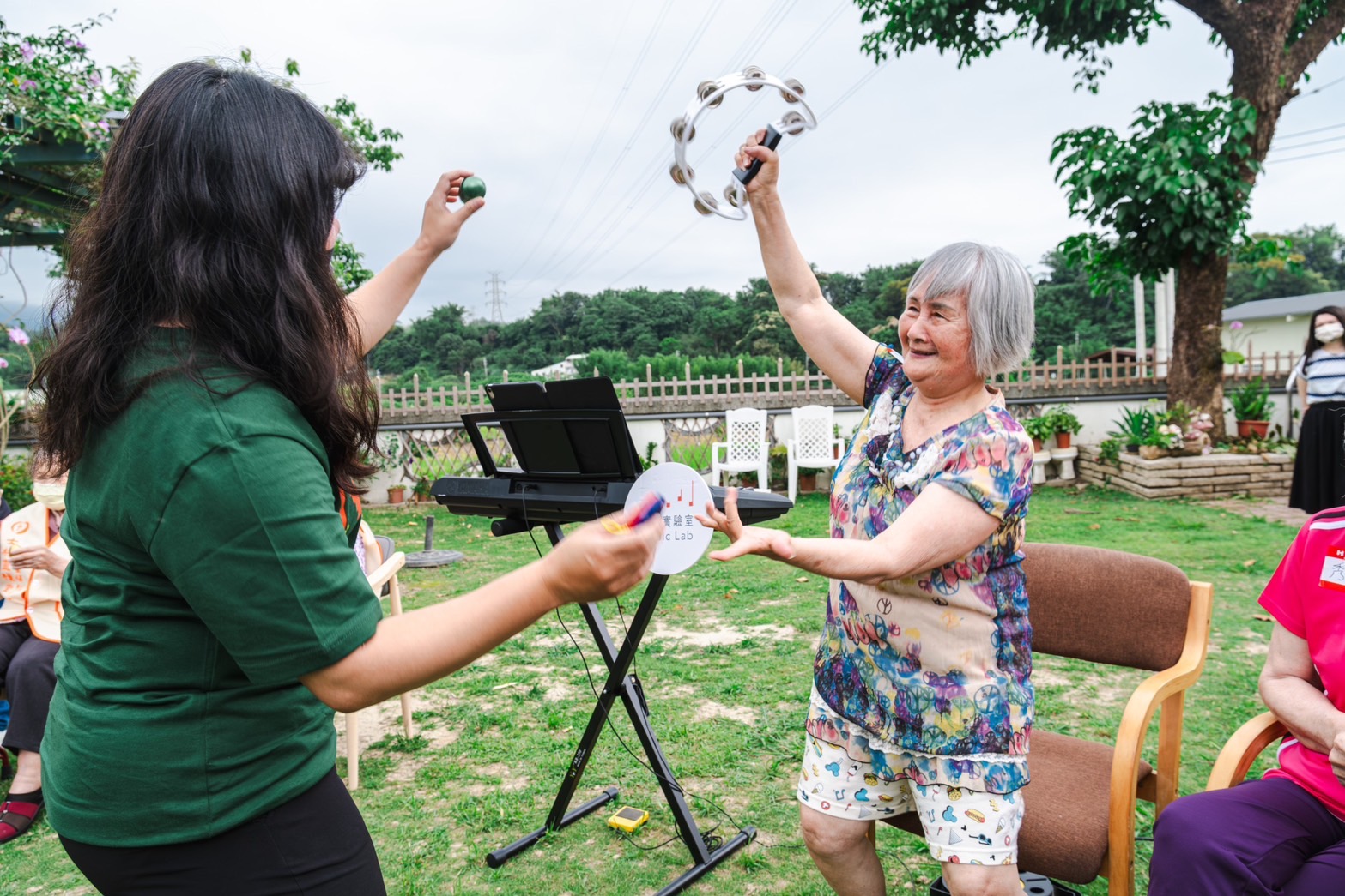 Seniors happily dancing with music pathfinders in the senior music care program.
